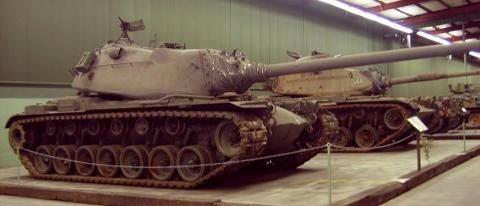 Museum with tank inside building facing right