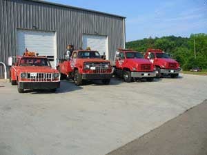 Exterior building with 4 big red trucks outside
