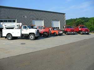 Exterior building with sideshot of 5 big trucks outside